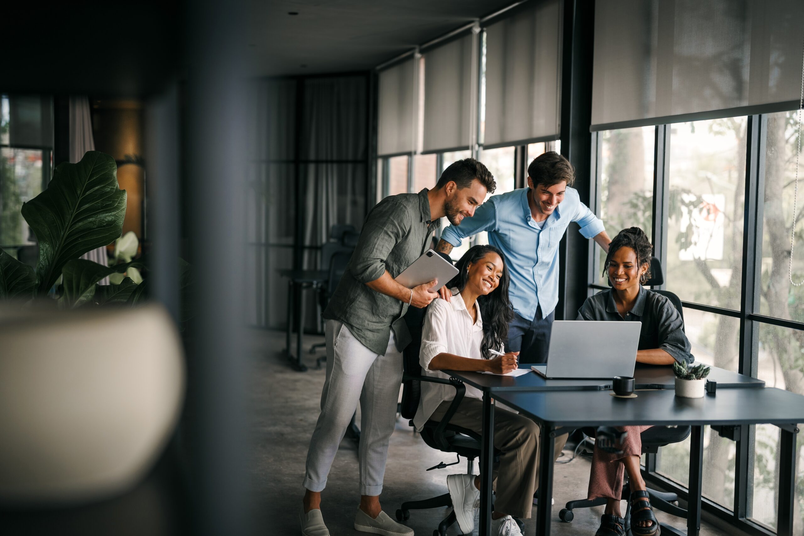 A group of direct marketers working together in the office.